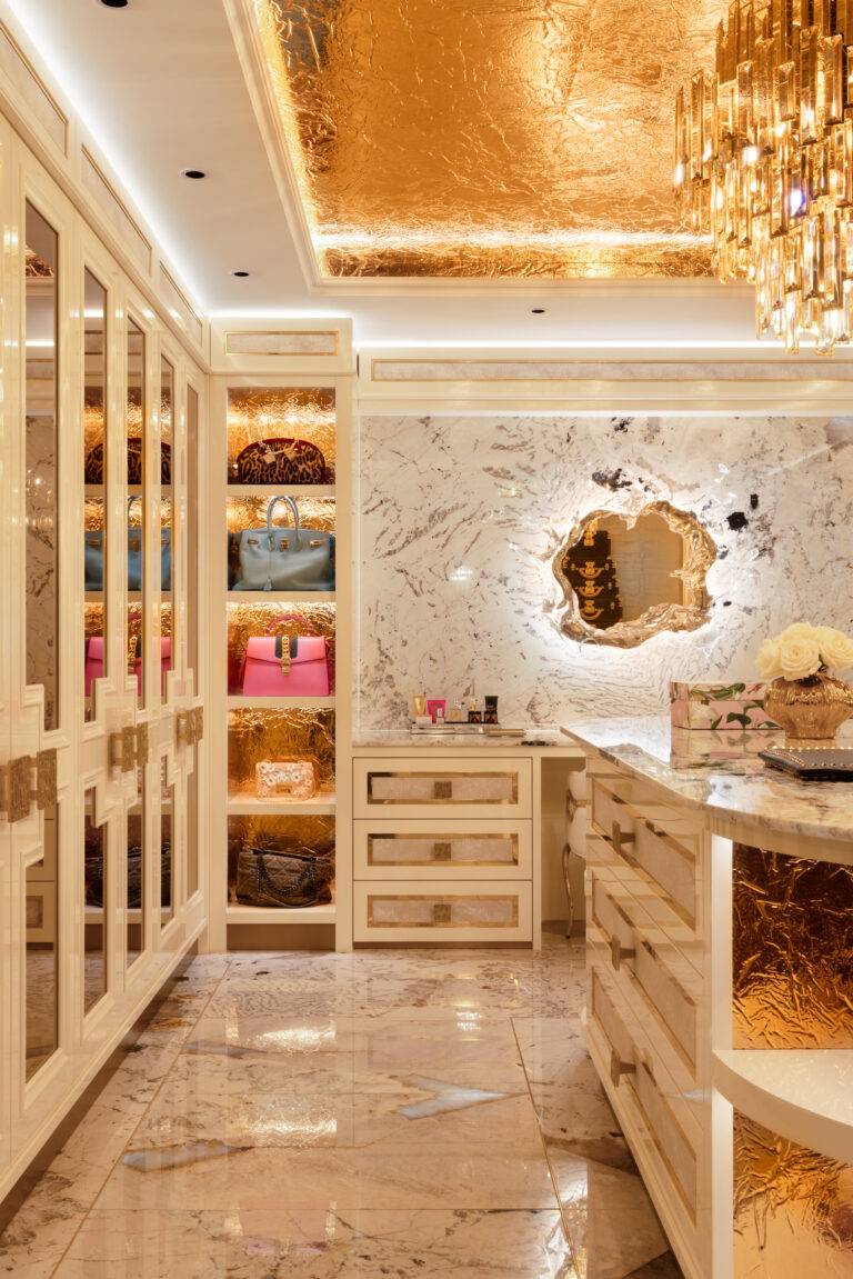 Dressing room with gold-leaf ceiling, mirrored wardrobes, illuminated handbag shelving and a stone-topped vanity