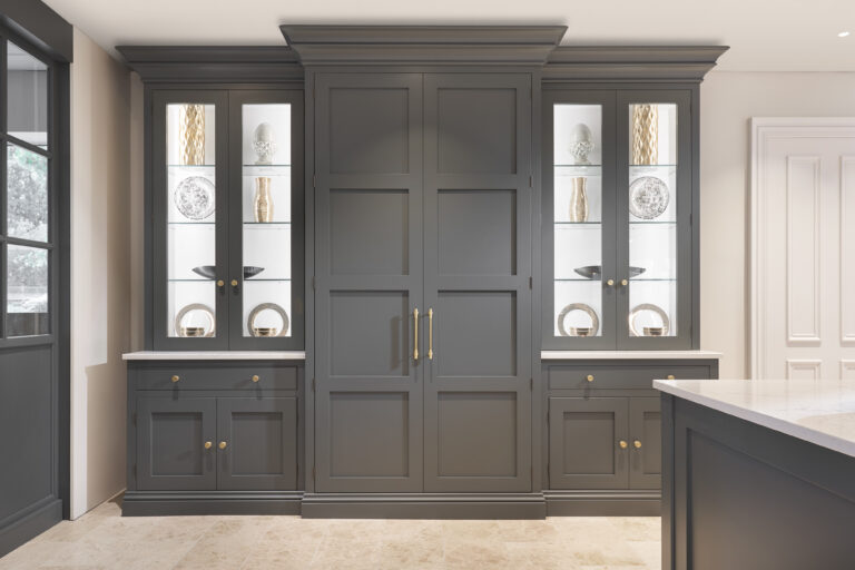 Tall Down Pipe pantry cupboards flanked by glazed display cabinets with brass handles and glass shelving