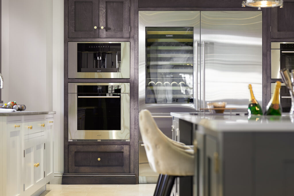 Chocolate Oak cabinetry houses integrated ovens, a coffee machine and a wine fridge beside the island