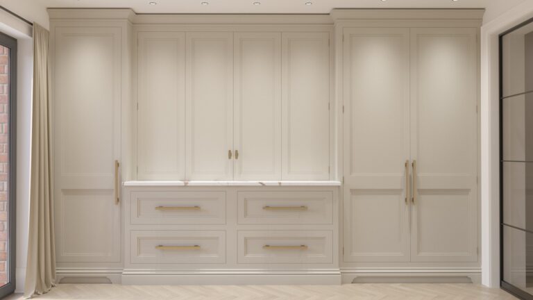 Floor-to-ceiling fitted wardrobes with a central drawer unit topped by a Calacatta Volcano stone surface